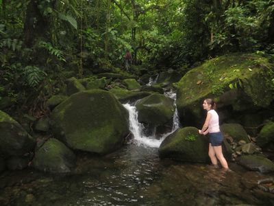 child playing in waterfall