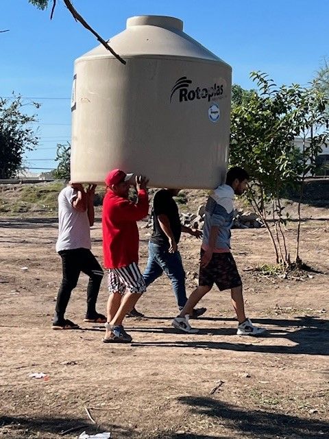 WUMC Border men moving water tank 224.jpg