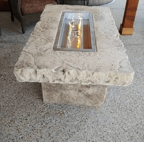 Hand-crafted decorative boulder fire table with built-in flame feature created by Boulder Designs