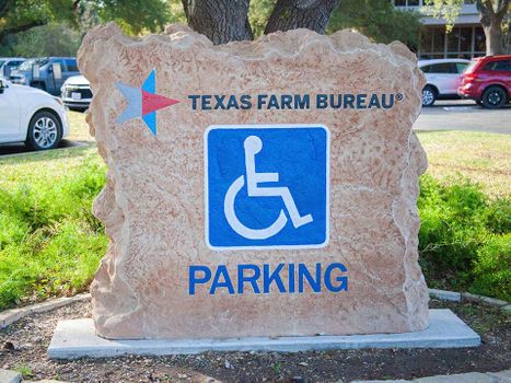 Custom engraved and etched stone commercial monument sign for accessible parking