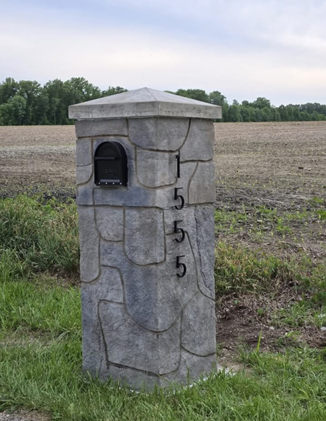 Custom crafted stone mailbox pillar with vertical house numbers
