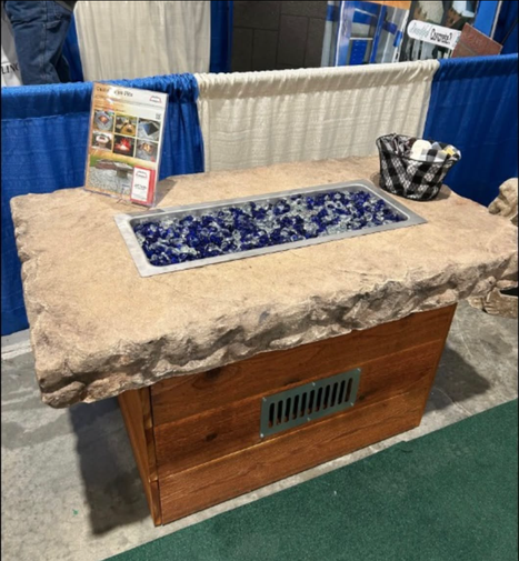 Custom boulder fire pit table with glass fire media by Boulder Designs