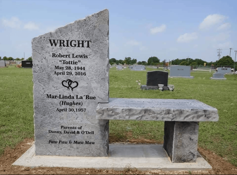 Custom engraved companion memorial stone bench with names, dates, and tribute text installed in a cemetery landscape.