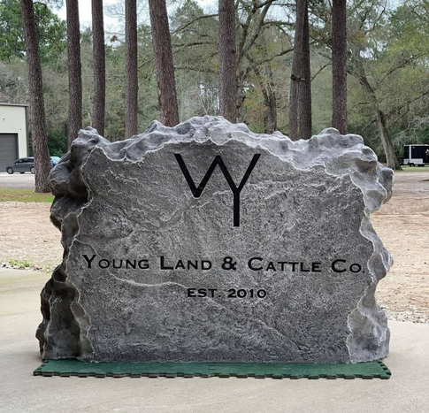 Custom crafted engraved boulder ranch entrance sign with logo