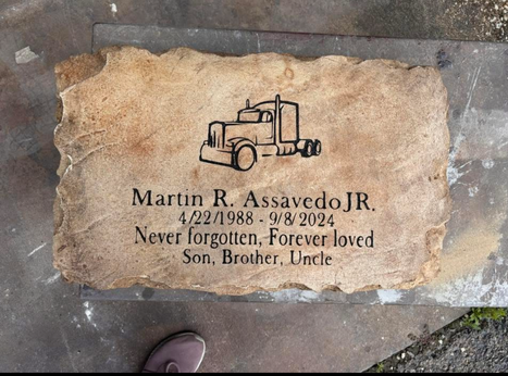 Affordable tan flat memorial headstone engraved with name, dates, and semi truck