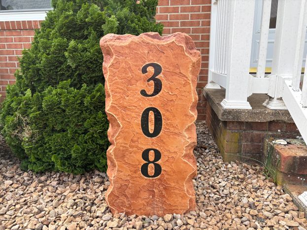 Tall engraved stone address marker displaying the house number 308 in black numbers beside a brick home in Bridgewater, VA, created by Angelopulos StoneCraft
