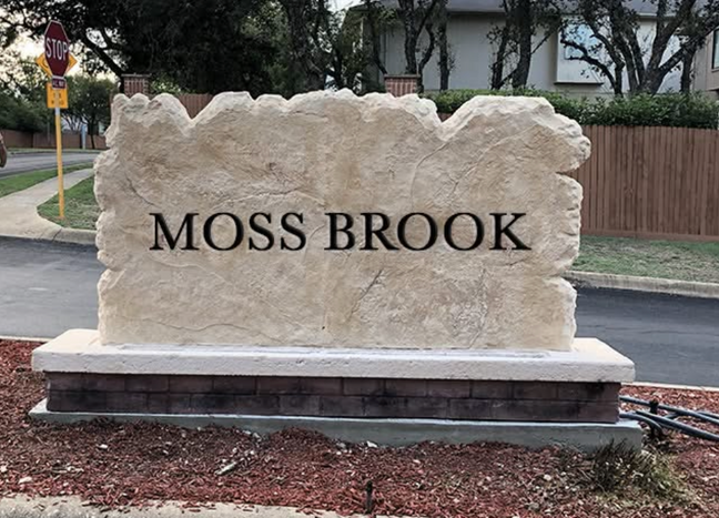 Custom carved stone commercial entrance sign for Moss Brook neighborhood