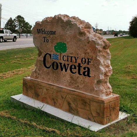 Custom carved stone commercial welcome sign for the City of Coweta roadside entrance