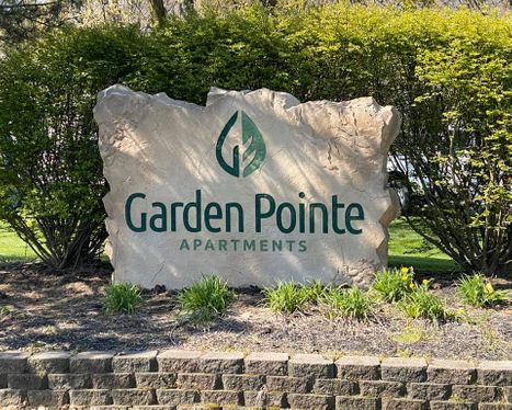 Custom carved stone commercial entrance sign for Garden Pointe Apartments