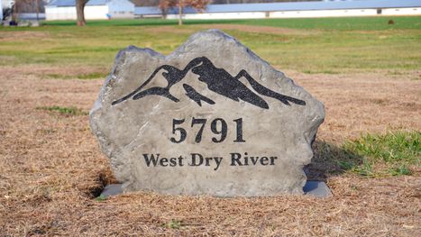 Custom engraved residential address boulder for 5791 West Dry River featuring mountain artwork, created by Angelopulos Stonecraft in Bridgewater