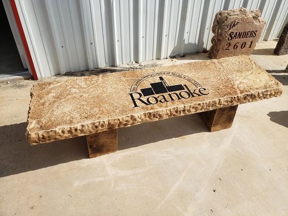 Custom engraved decorative boulder bench featuring Roanoke, Texas seal