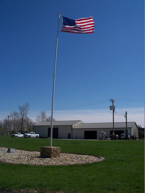Decorative boulder flagpole base by Boulder Designs
