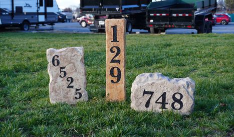 Collection of custom engraved residential address number boulders and stone markers created by Angelopulos StoneCraft