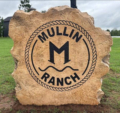 Engraved Mullin Ranch boulder sign with rope circle and M monogram