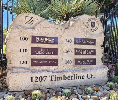 Custom crafted engraved boulder business directory monument sign