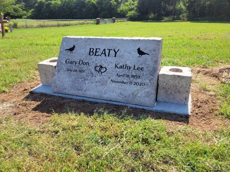 Personalized slant memorial headstone engraved with couple’s names and dates