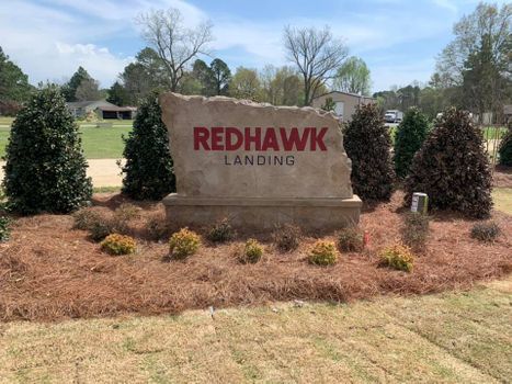 Custom engraved and etched stone commercial entrance sign for Redhawk Landing