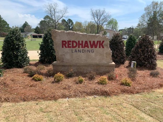 Custom engraved and etched stone commercial entrance sign for Redhawk Landing