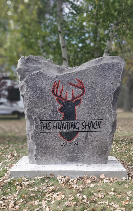 Engraved hunting shack boulder sign with deer silhouette and est 2024