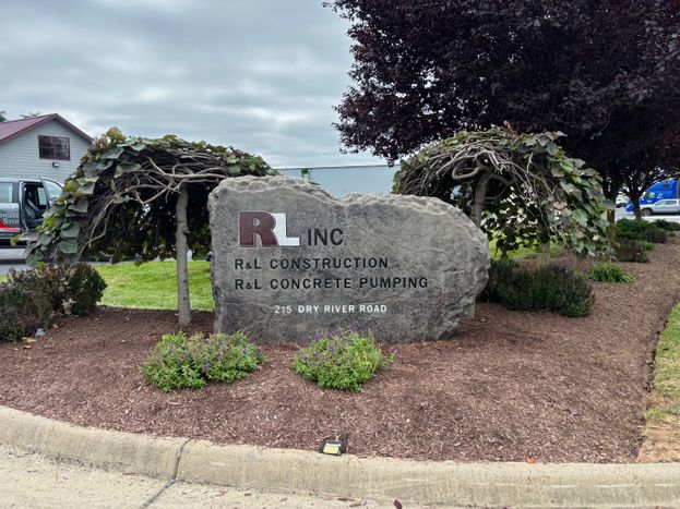 Custom engraved commercial boulder entrance sign for R&L Inc construction and concrete pumping business created by Boulder Designs
