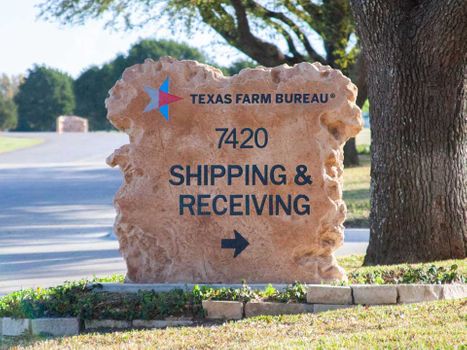 Custom engraved and etched stone commercial shipping and receiving directional monument sign