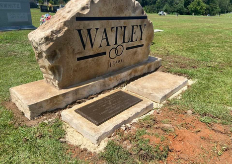 Affordable engraved stone boulder headstone with family name and bronze memorial plaque