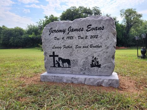 Affordable engraved stone boulder headstone with cross horse and campfire symbols