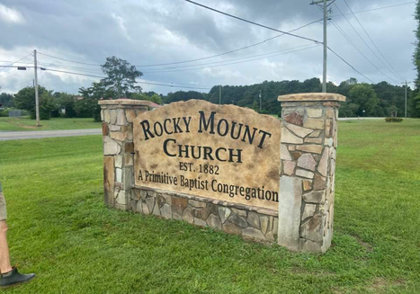 Etched and engraved rock and boulder church monument sign with decorative pillars