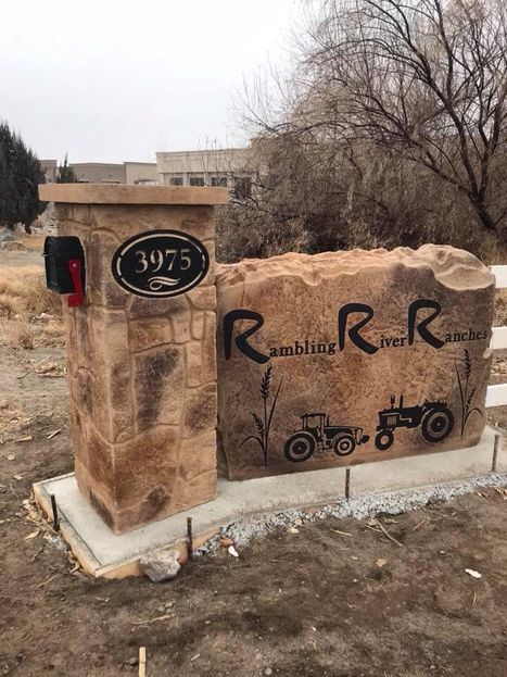 Hand-made ranch entrance stone sign with mailbox and address plaque