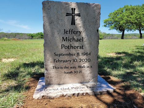 Affordable light gray upright memorial headstone engraved with cross, name, and Bible verse