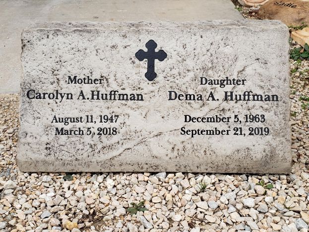 Affordable light gray flat memorial headstone engraved with names, dates, and cross