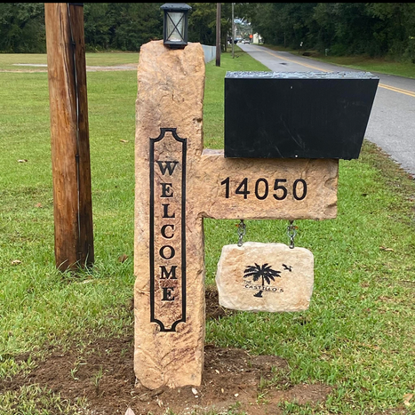 Custom crafted engraved stone mailbox post with hanging name sign