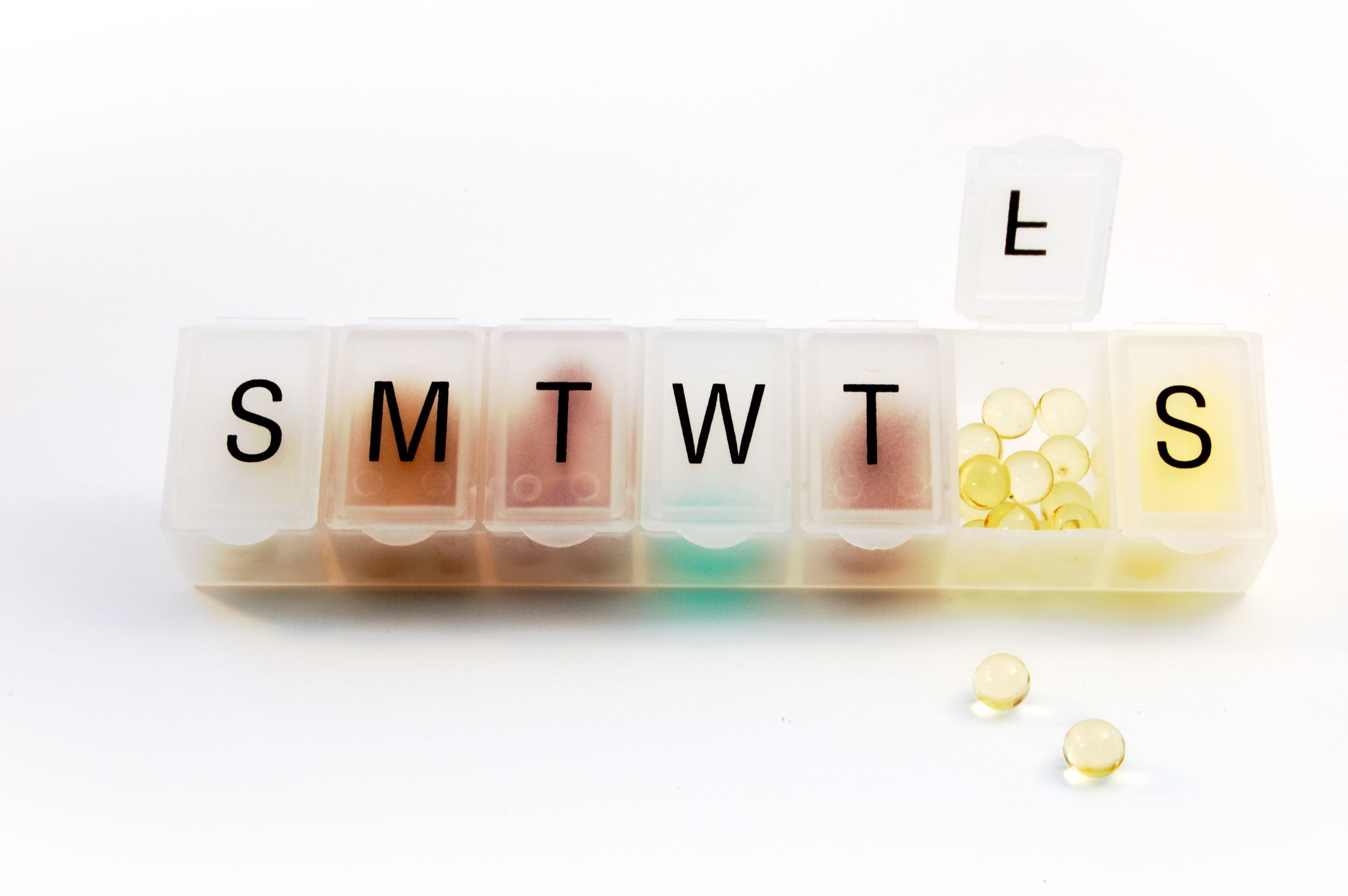 Pill organizer with pills inside. Medication Adherence