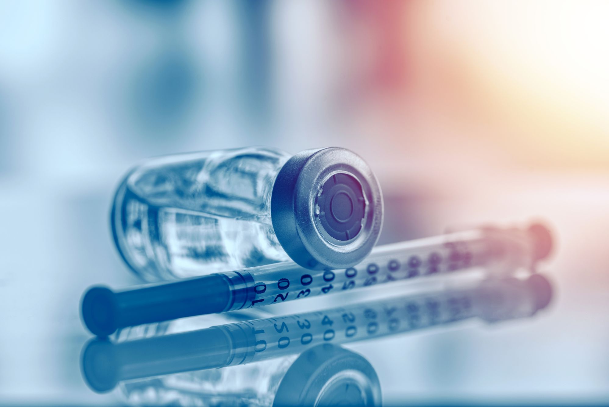 Image of a syringe and a vaccine vial Immunizations