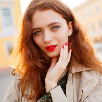 outdoor-close-up-portrait-lovely-ginger-woman-with-wavy-hairs-beige-coat-red-lips-nail.jpg