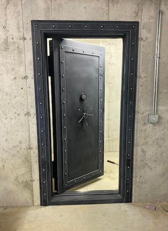 the outside view of a properly installed dark grey steampunk vault door.