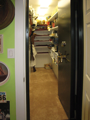 a vault door installed in a closet that is open up to show the inside of the safe closet. a vault door installed in a closet that is open up to show the inside of the safe closet.