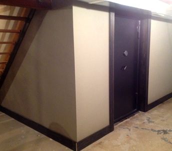a vault room door installed under a staircase. a vault room door installed under a staircase.