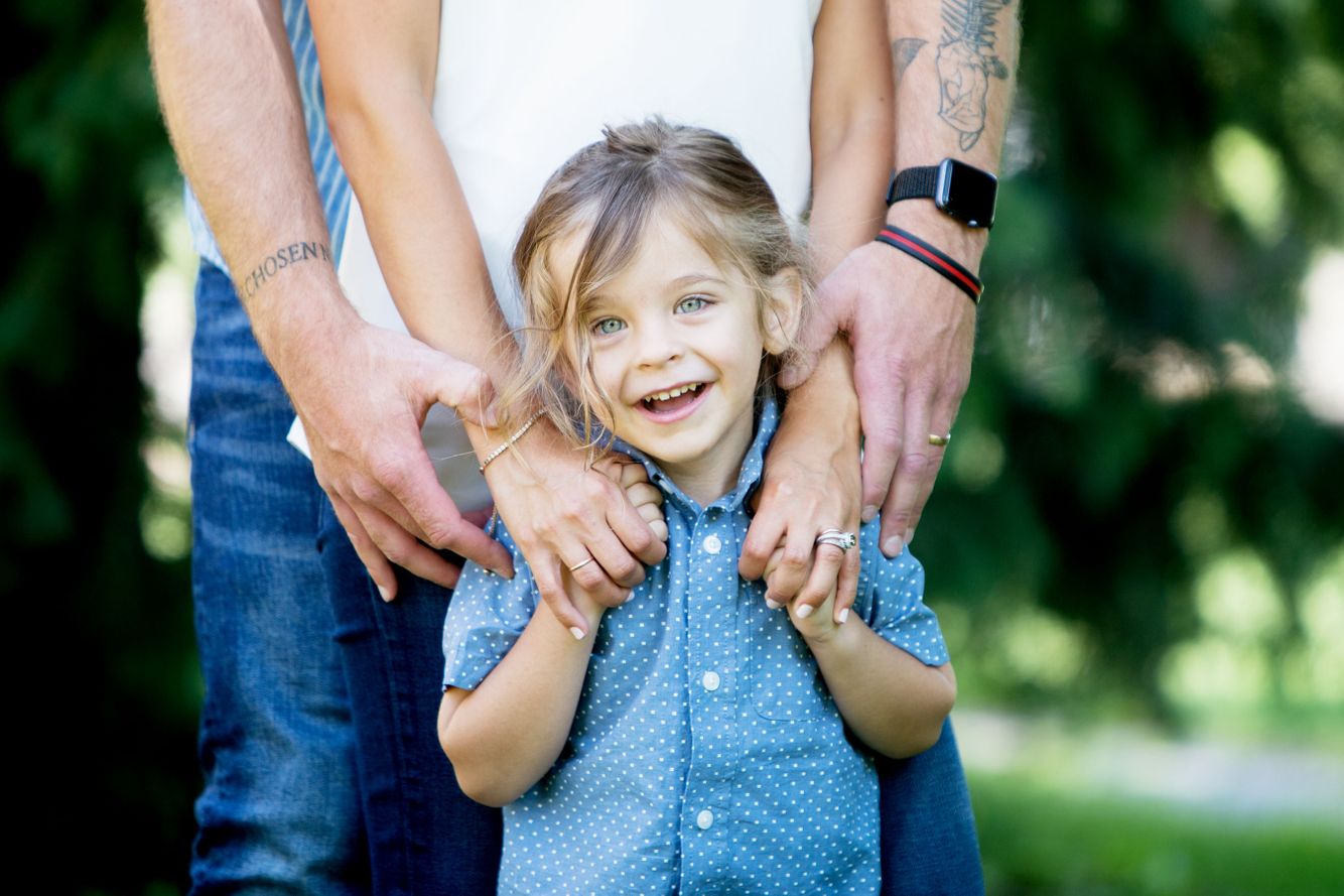 Mom and Dad holding their son in a photo shoot at Wash Park. 