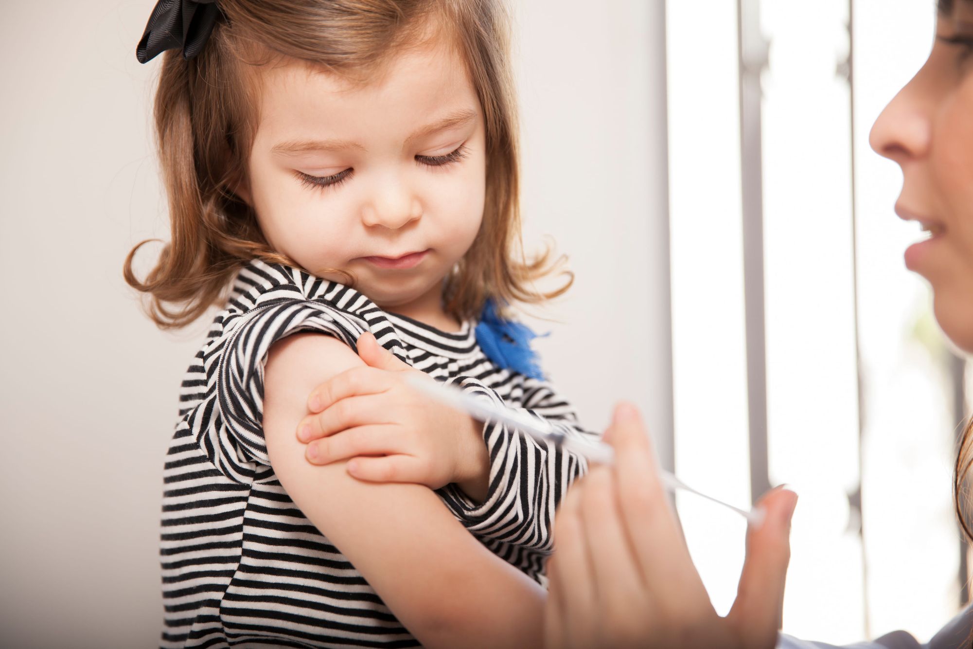 Young child receiving a vaccine Immunizations