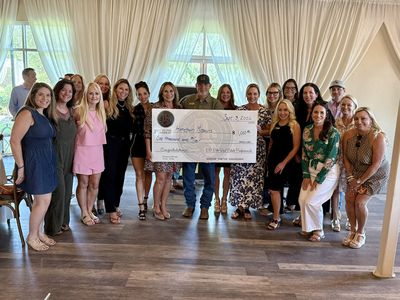 Dripping Springs Elite Real Estate Professionals presents another $1,000 donation to Hometown Missions on September 3, 2026. Hometown Missions Board Member Trey Powers, center, accepts the contribution on behalf of the organization. dripping-springs-elite-hometown-missions-donation-2026.jpg
