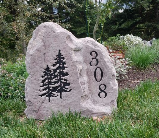 Combined house numbers and graphic engraved on stone.