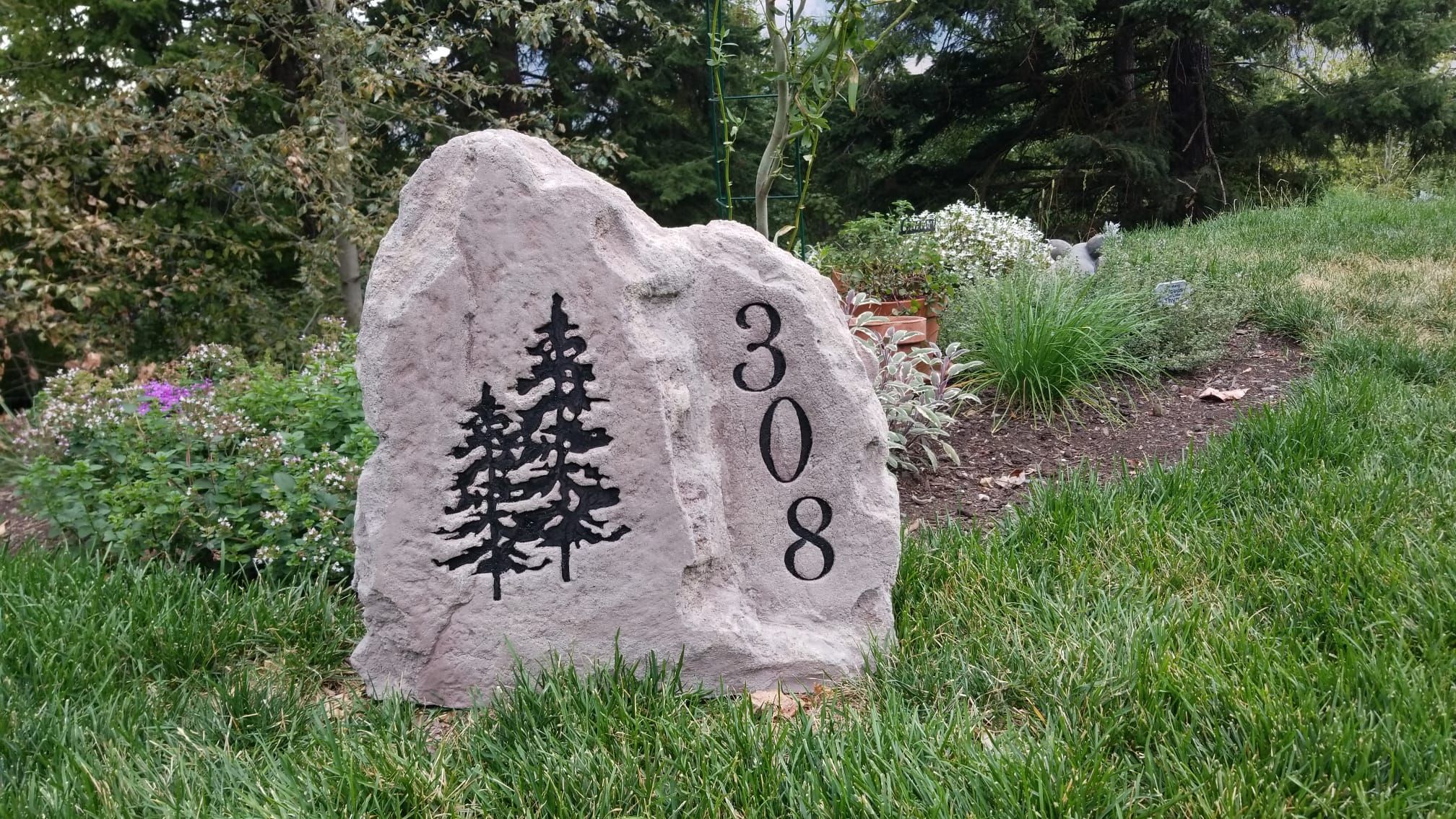 Stone house number sign with a personalized graphic