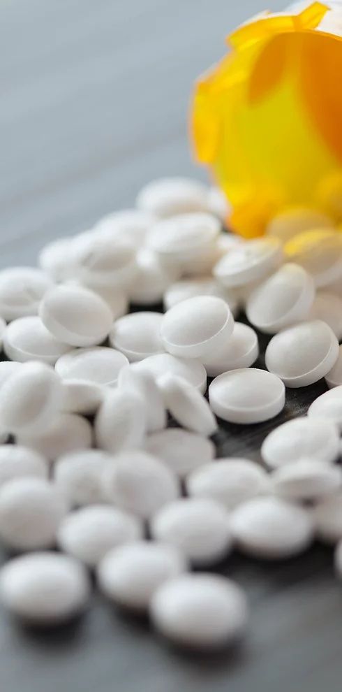 Pill bottle spilled over Prescription Drug Cost Analysis