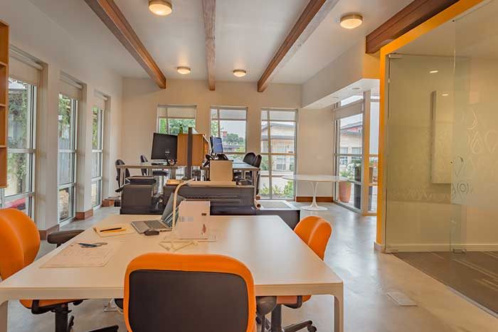 Inside an office. There is a large table with chairs around it and a glass wall of a conference room to the right. 5