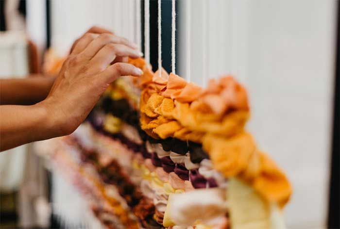 Hands adjusting cloth on a loom 6