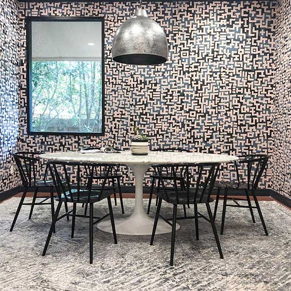 Conference room with a round table and wacky wall paper 6
