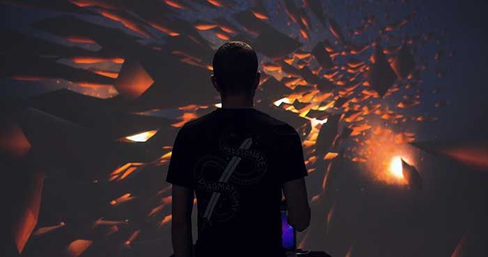 Person staring at a wall installation of flying rocks and bright flight 5