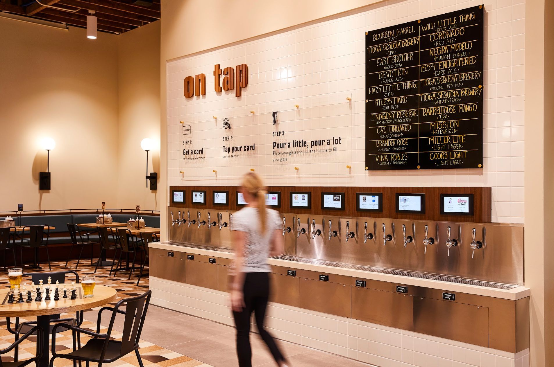 On tap beer wall and dining room seating at Mainzer in Downtown Merced, a Restaurant, Music Venue, and Movie Theater Beer Wall & Dining Room in Mainzer Merced | Restaurant, Music Venue, and Movie Theater