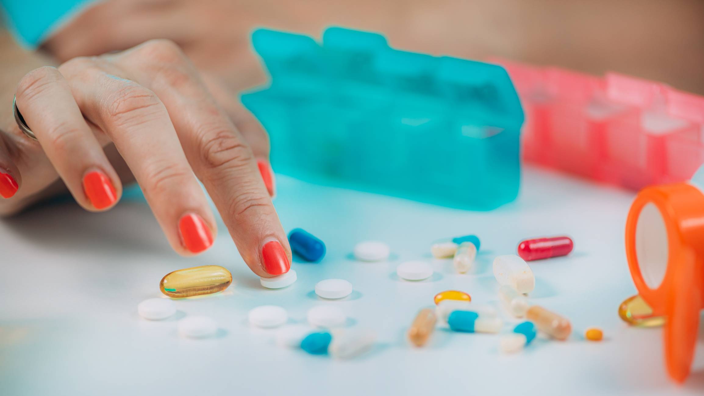Woman sorting through her medication Medication Adherence